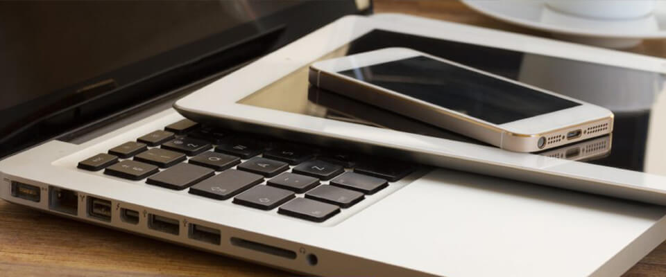 Laptop, tablet and phone stacked on top of eachother