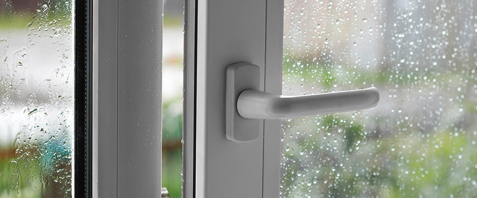 Rain drops on open PVC window