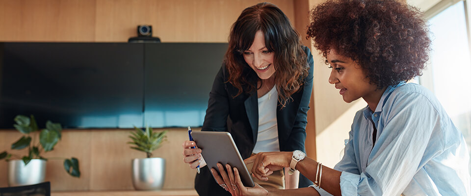 Two women looking at a tablet