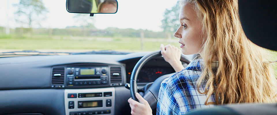 Young woman driving a car